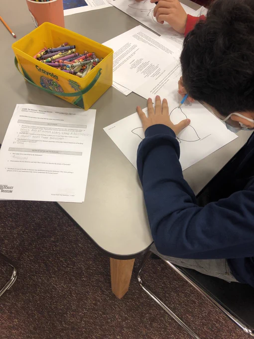 Students color butterflies as part of The Butterfly Project