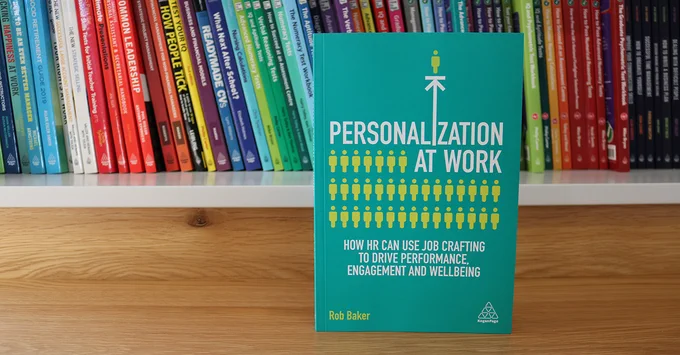 'Personalization at work' by Rob Baker on a shelf, with books in the background.
