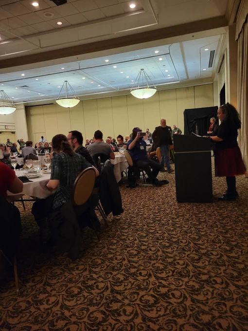 LBB director announcing an award recipient at Dining in the Dark 2022