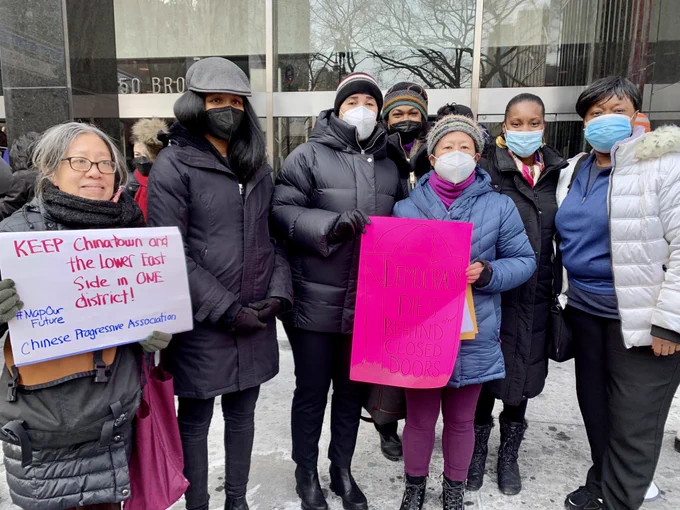 Griffith and Rose pose with advocates holding signs that read "Keep Chinatown and the Lower East Side in one district!" and "Democracy dies behind closed doors."