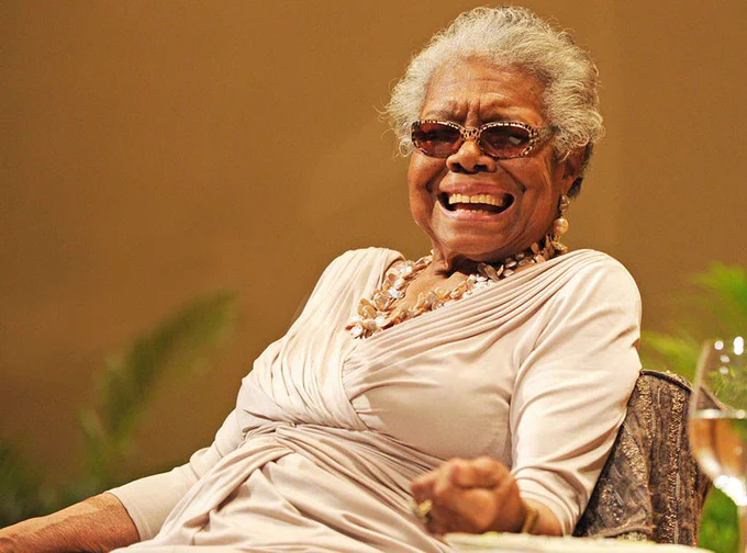 An image of Maya Angelou seated and smiling.