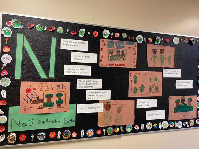 Bulletin board with drawings and writing about the Number 2 Construction Battalion. 