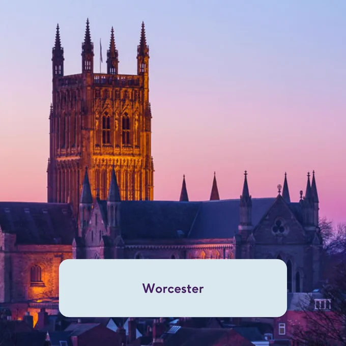 Image shows Worcester cathedral exterior with blue and pink sky.
