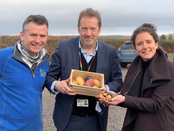 From left to right, IGS Limited CEO David Farquhar, James Hutton Institute CEO Prof Colin Campbell and the Scottish Government's Rural Affairs secretary, Mairi Gougeon MSP, with potatoes from the Commonwealth Potato Collection in an outdoor setting. Photo: James Hutton Institute