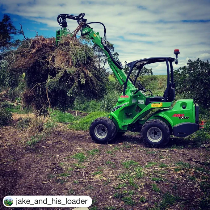 Avant green front loader lifting bundle of branches #whyskidwhenyoucansteer #skidsteer #workhard #outdoor #branches 