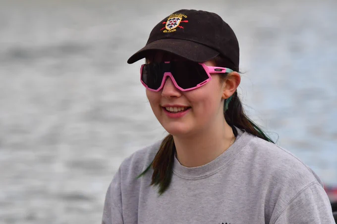 Becky Hore, SCBC Women's Captain, pictured on the water in a college cap and pink polarised glasses