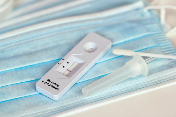 A RAT test laid out on a surgical mask. 