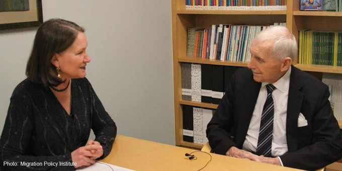 A photo of two people talking.