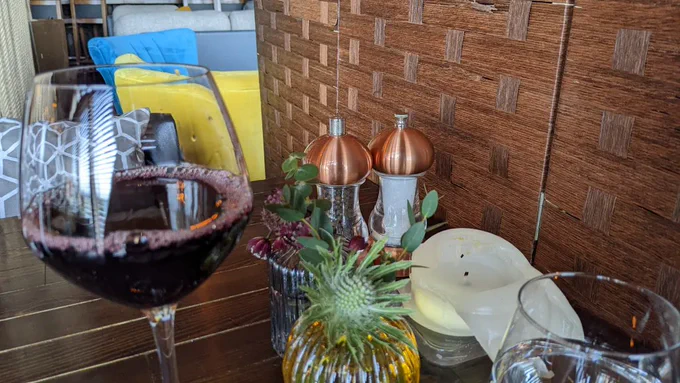 red wine on table beside melted candle