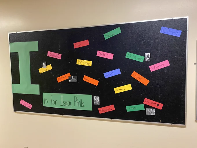 Bulletin board with photos and words to describe Isaac Phills.