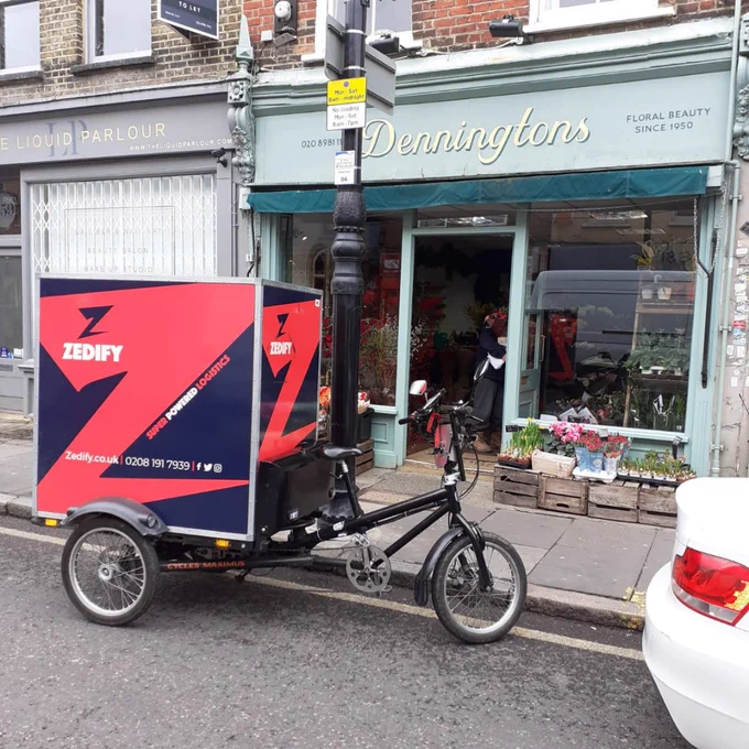 Zedify rider picking up flower deliveries for Denningtons florists in E14, London