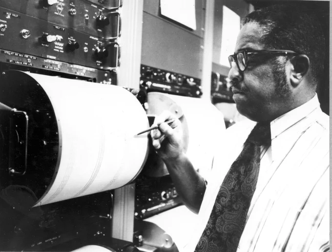 Seismology and Seismometry. Staff geophysicist Waverly Person points to the trace of an earthquake which triggered an alert at the U.S. Geological Survey National Earthquake Information Service in Golden