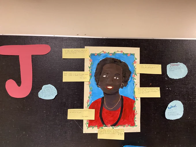 Bulletin board with a painting of Jean Augustine and quotes.