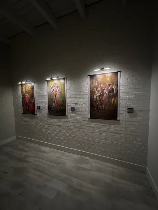 Three AI artworks on display at an art gallery.