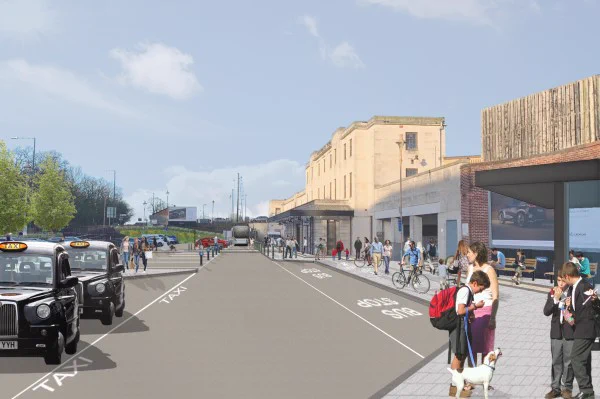 View of station entrance welcome to leamington with taxis on left and pedestrians on right.