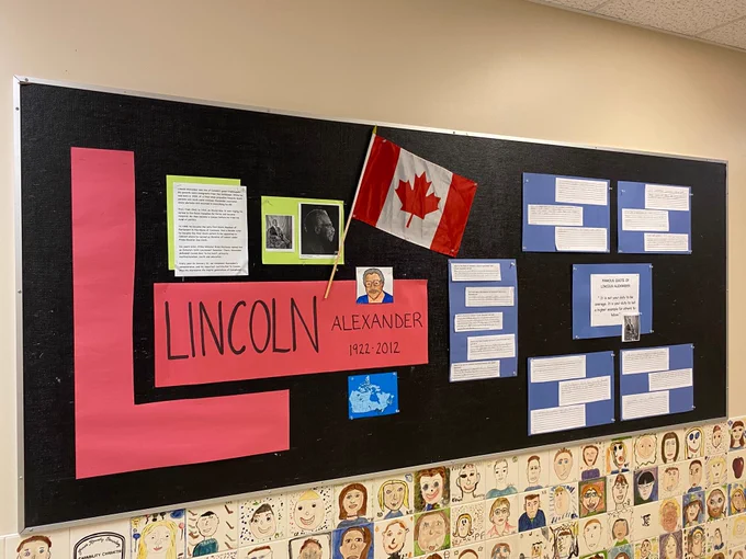 Bulletin board with photos and info about Lincoln Alexander. 