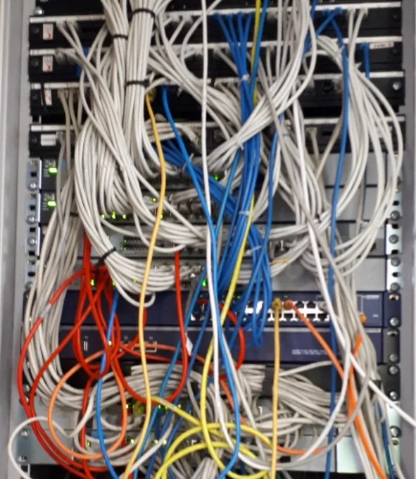 More like a birds nest than a comms cabinet and those switches are over 10 years old. Pretty much a liability to reliability.