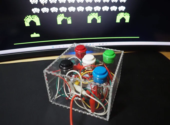 mini arcade box built into a custom clear acrylic box with makey makey, testing with space invaders video game