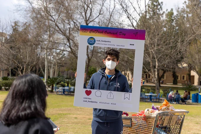 Student posing for photo during CSUB CalFresh resource fair.
