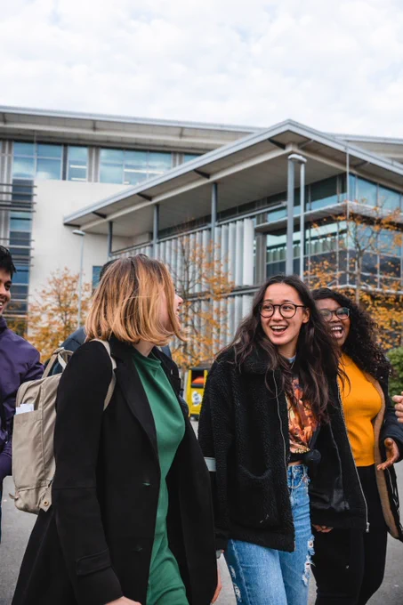 Three students walking on campus