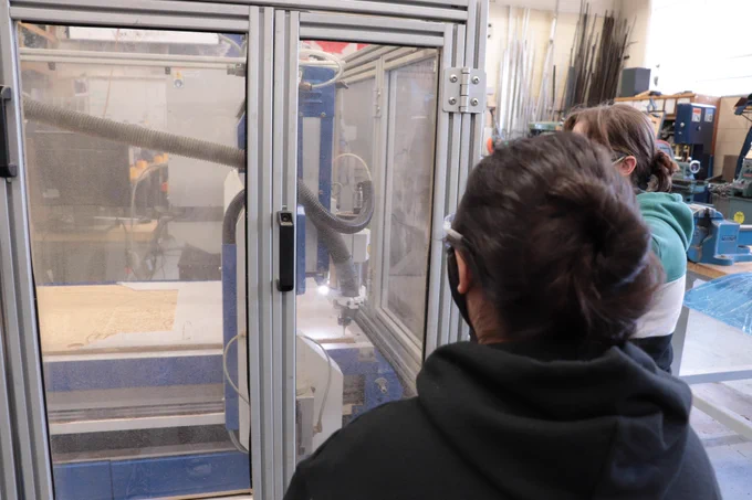 Manufacturing members watching our CNC machine.