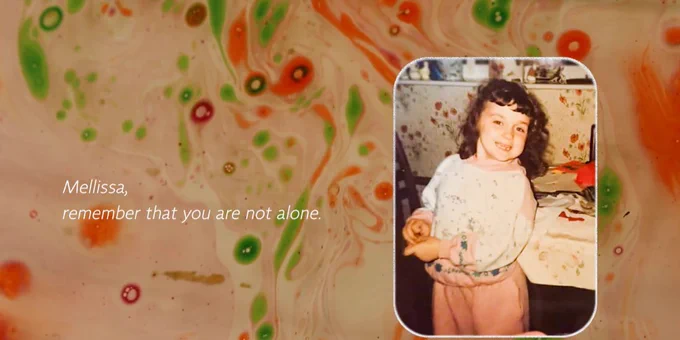 White writing on the left saying 'Mellissa, remember that you are not alone.' On the right is a picture of Mellissa as a little girl smiling at the camera and the background behind the writing and picture is swirls of red and green.