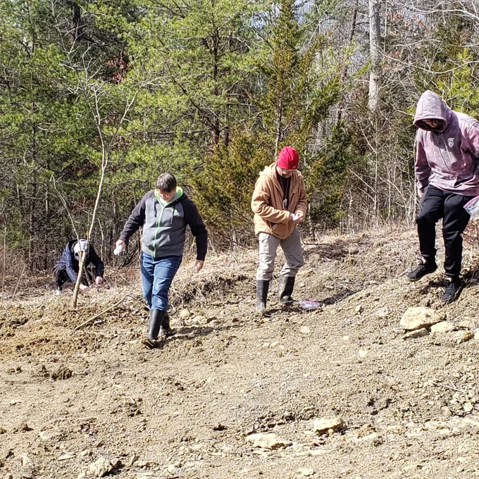 students and Colin Sumrall surface collecting fossils