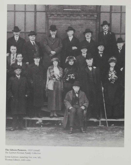 A black and white photo showing a group of people in formal dress staning in three rows.