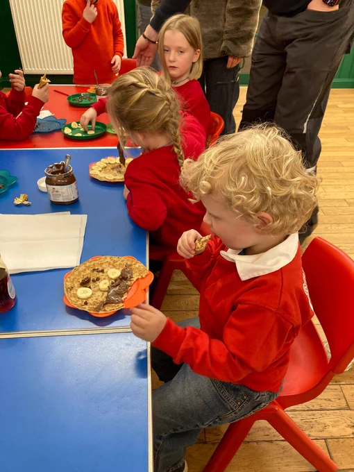 Squirrel Scouts making pancakes with bananas and chocolate spread