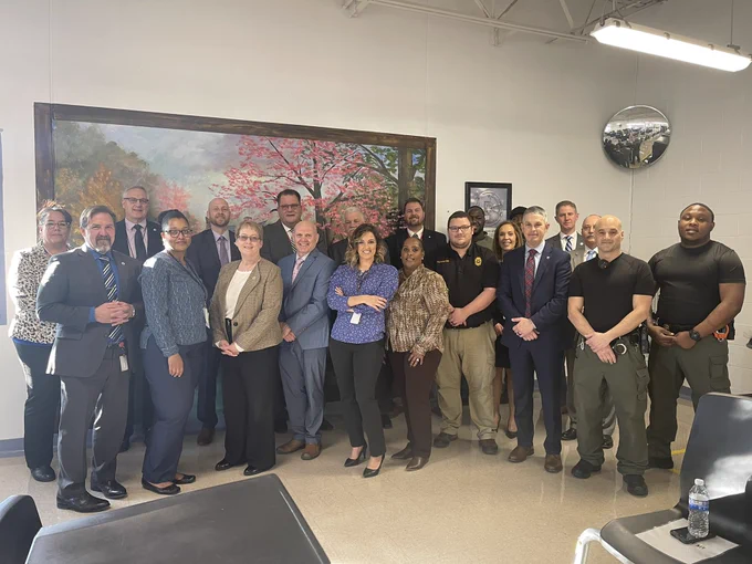 Large group of corrections and DIDD employees in large conference room