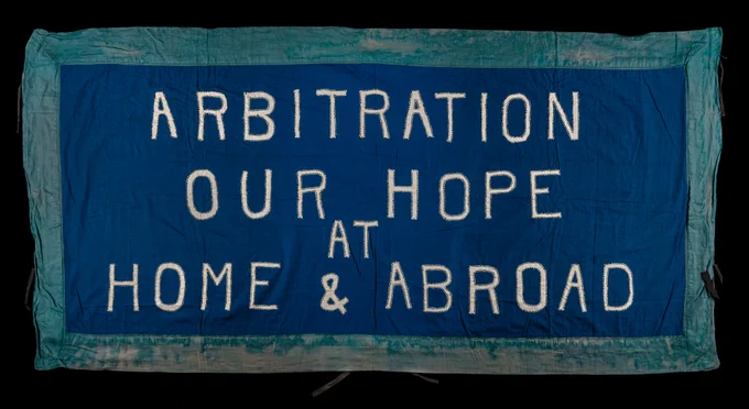 A banner. Blue, white and ocean green with the text "Arbitration Our Hope At Home & Abroad".