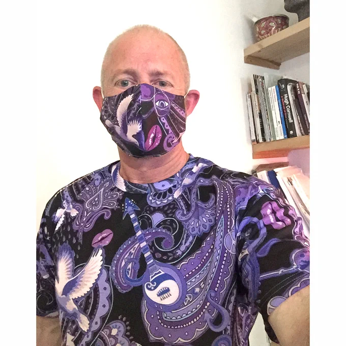 Designer Patrick Moriarty wearing Prince-themed t-shirt and mask