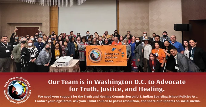 Photo of Large crowd holding up an orange sign that says Bring our children home. Our team is in Washington DC to advocate for truth, justice and healing. We need your support for the truth and healing commission on us Indian boarding school policies act. Contact your legislators, ask your tribal council to pass a resolution and share our updates on social media.