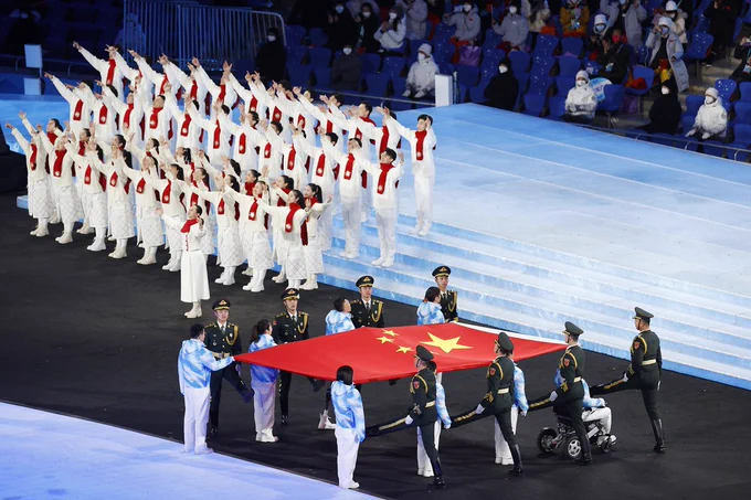 China flag held as performers surround them
