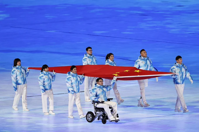 Eight Chinese athletes hold their national flag