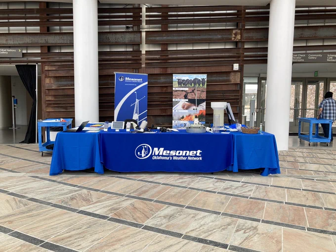 Mesonet booth display with instruments, 3-d rainfall models, and kid activities.