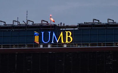 University of Maryland, Baltimore logo lit in Blue and Yellow