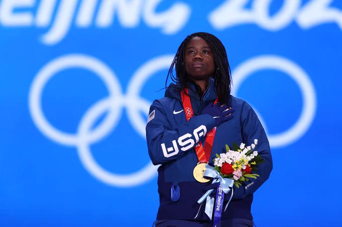 Speedskater Erin Jackson stands with gold medal as the United States Anthem is played at the Beijing 2022 Olympic Games. 