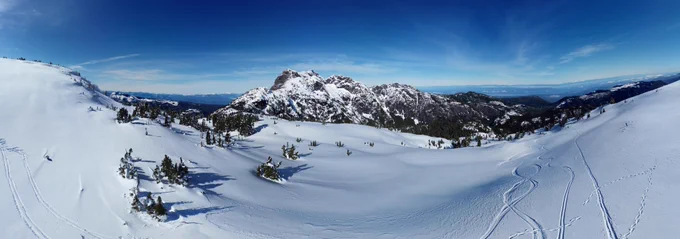 Panorama of snow mount arrowsmith with ski tracks