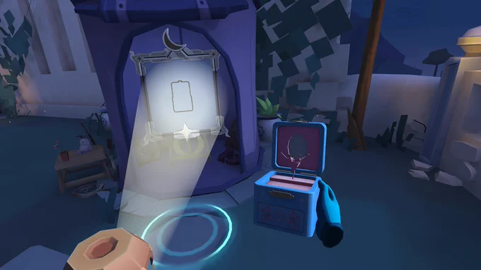 A picture of a music box with a ballerina is in the player's right hand and in their left a beam of light is coming out, reflecting on a picture frame with a moon etched at the top. The area is outdoors, with the night sky visible from the upper right and grassy verges creeping up the walls. There is a small coffee table near the frame which has an abandoned pot plant on it.