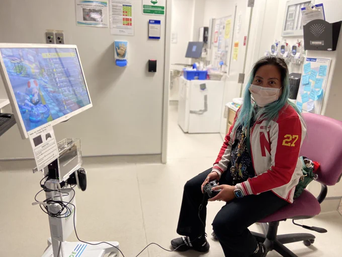 Nurse playing video games on new gaming cart