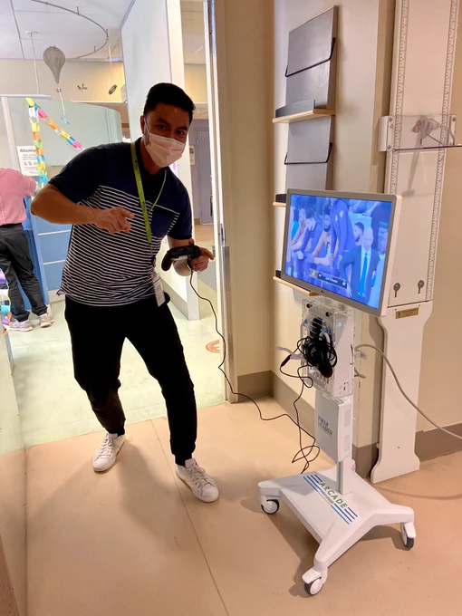 Nurse playing video games on new gaming cart