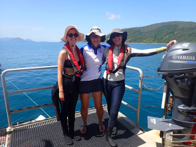 Melissa Naugle, Grandma Bay and Emily Howells on the MV Magnetic with Orpheus Island in the background
