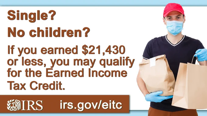 A photo of a delivery man, with gloves and a mask over his mouth, carrying two brown bags in his hands. Text, “Single? No children? If you earned $21,430 or less, you may qualify for the Earned Income Tax Credit.” IRS logo. Irs.gov/eitc 