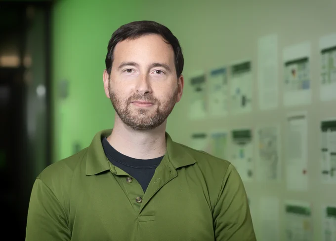 Photo of Mark Albert wearing a green shirt.