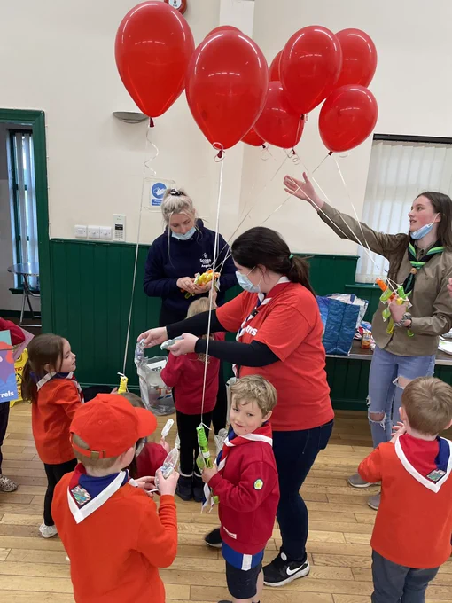 Squirrel Scouts getting a red balloon