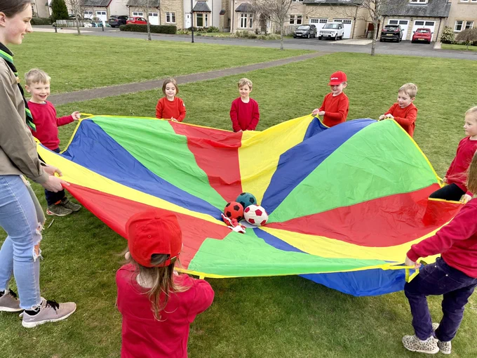 Squirrel Scouts playing parachute games