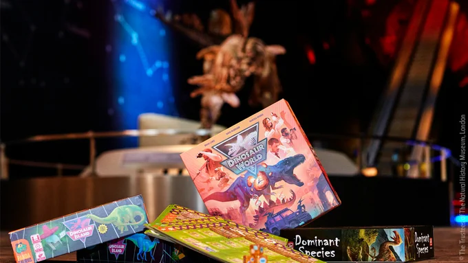 Dinosaur board games in front of Sophie the Stegosaurus
