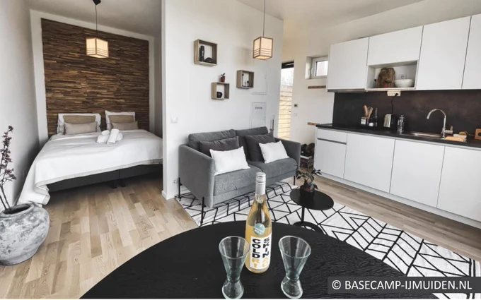 Internal image of a compact home showing bedroom, living room and kitchen area