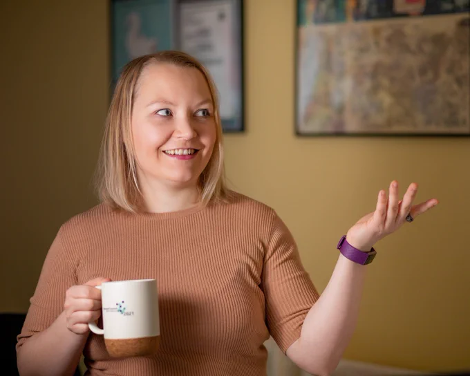 Me holding a mug and happily gesturing at something offscreen / nothing